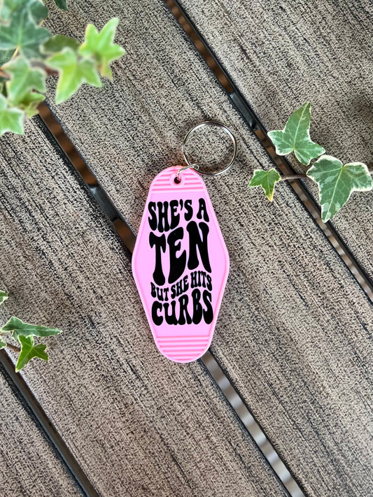 She Hits Curbs Motel Keychain